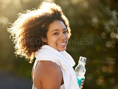 Buy stock photo Portrait of an attractive young woman getting a drink during her workout
