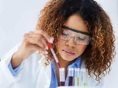 Buy stock photo Cropped shot of a young female scientist separating samples in the lab