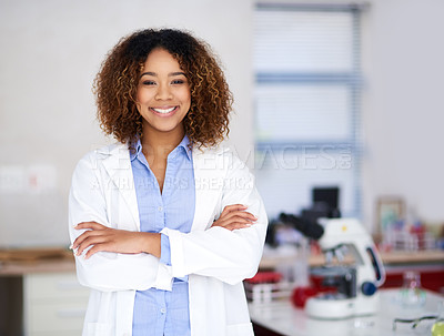 Buy stock photo Portrait of an attractive young scientist standing with her arms folded in the lab