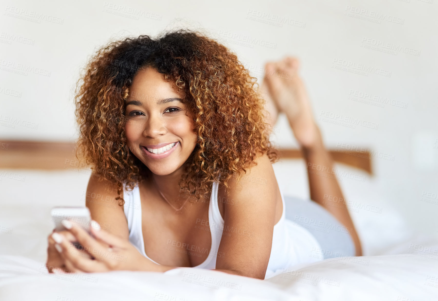 Buy stock photo Portrait, phone and texting of black woman on bed, home and dating site in app, reading and smile in apartment. Bedroom, happy and person with mobile, online and typing in web, relax or chat in house