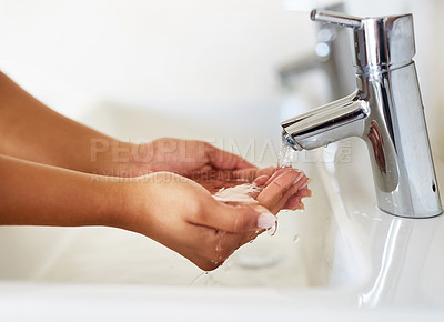 Buy stock photo Cropped shot of a young woman washing her hands