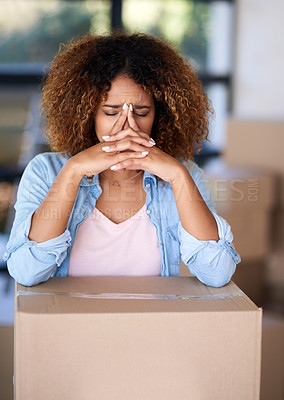 Buy stock photo Shot of a young woman looking worried after being evicted from her home