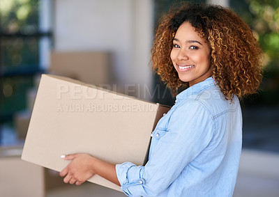 Buy stock photo Portrait of a young woman carrying a cardboard box into her new home
