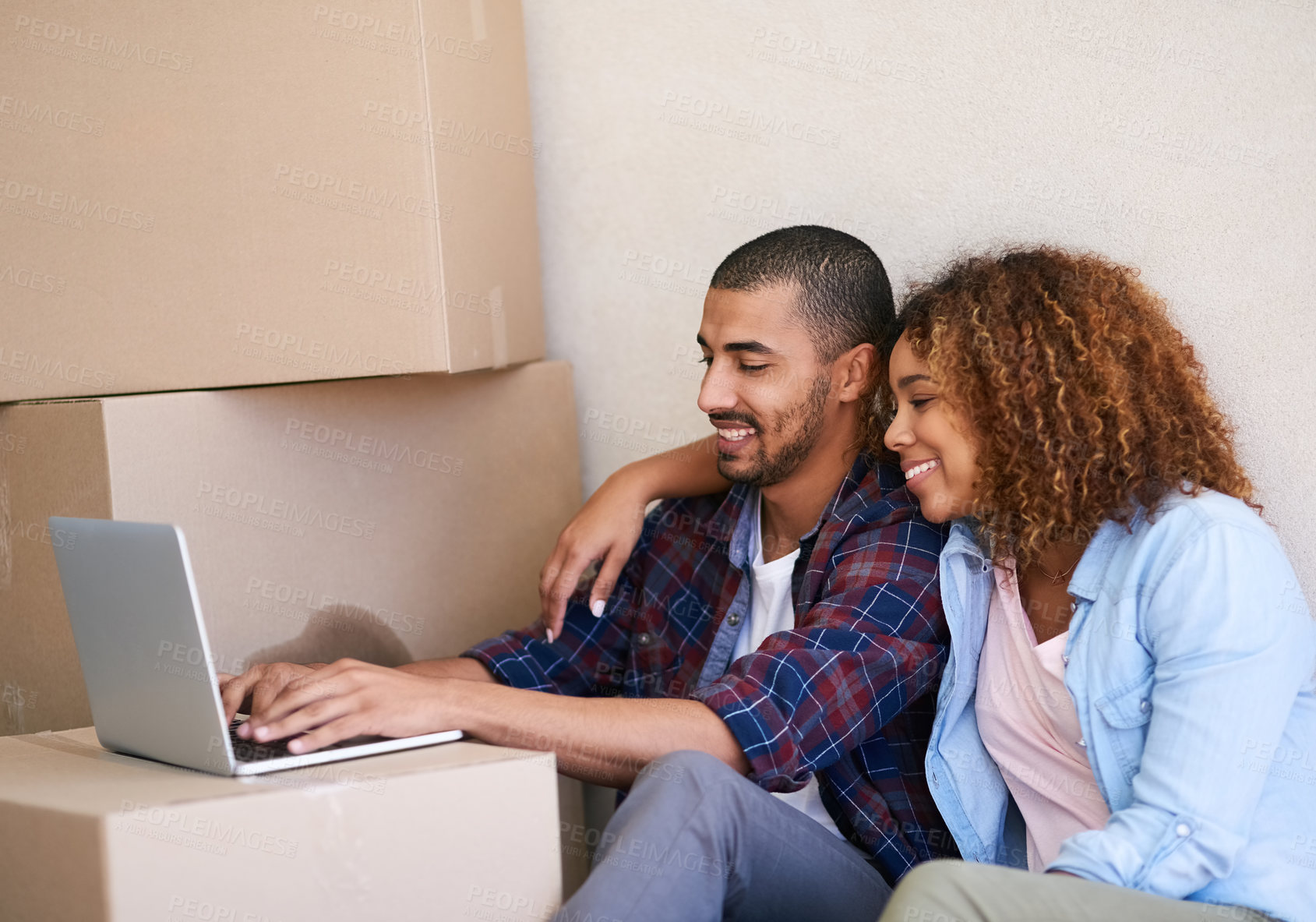 Buy stock photo New home, boxes and couple with laptop, smile and property with real estate, cardboard and goals. People, apartment and man with woman, internet or computer to pay mortgage, rent and bonding together