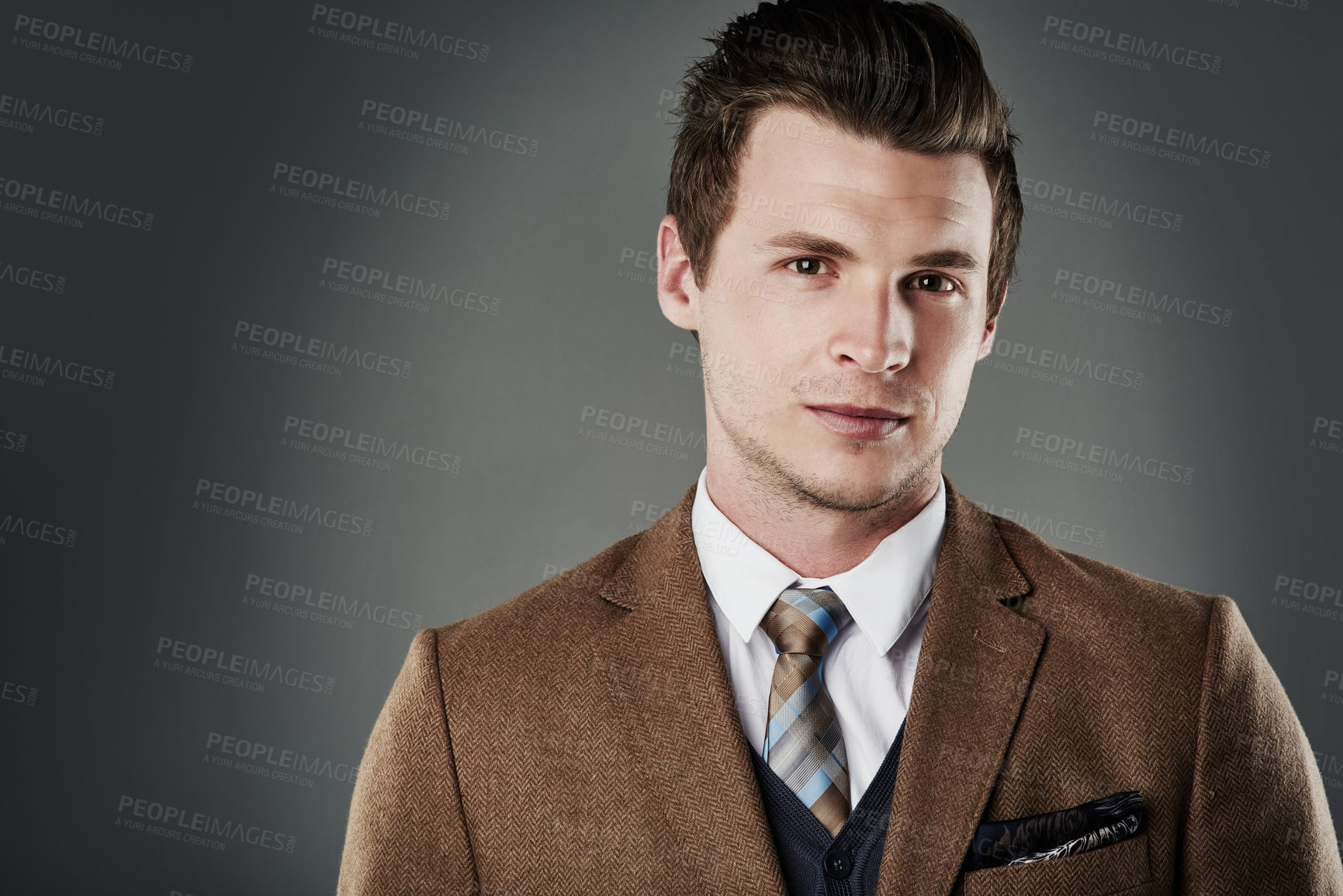 Buy stock photo Cropped shot of a young businessman posing against a grey background