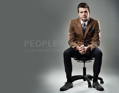 Buy stock photo Shot of a young businessman posing against a grey background