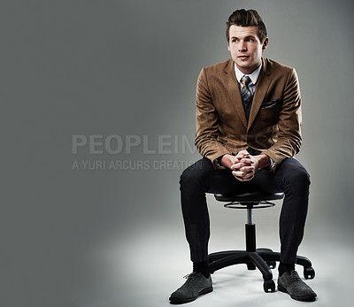 Buy stock photo Shot of a young businessman posing against a grey background