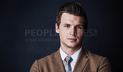 Buy stock photo Studio shot of a young businessman against a dark background