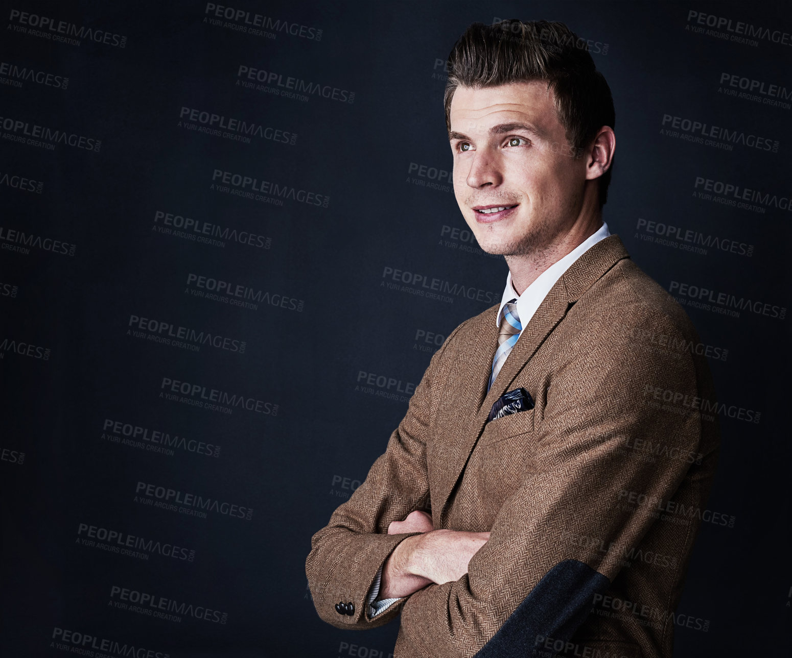 Buy stock photo Studio shot of a young businessman against a dark background