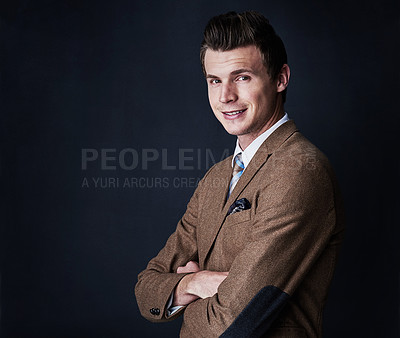 Buy stock photo Studio shot of a young businessman against a dark background