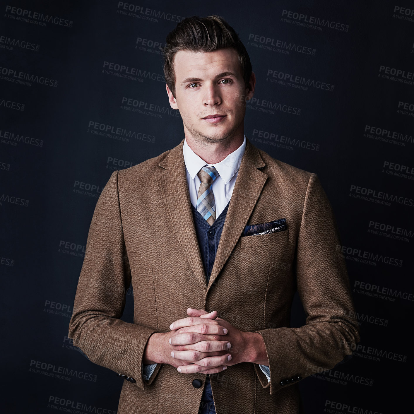 Buy stock photo Studio shot of a young businessman against a dark background