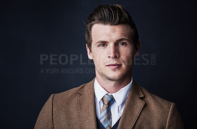 Buy stock photo Studio shot of a young businessman against a dark background