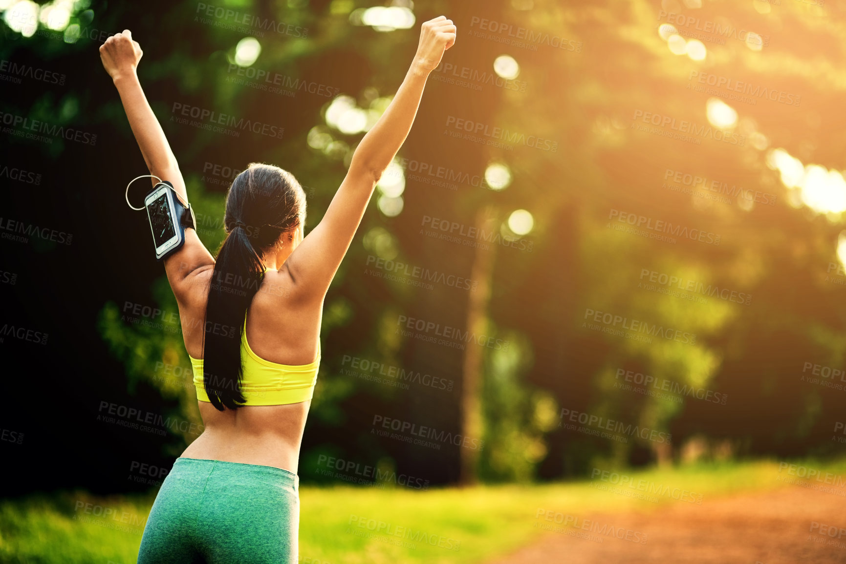 Buy stock photo Rearview shot of a sporty young woman celebrating a victory