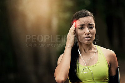 Buy stock photo Shot of a sporty young woman suffering from a headache