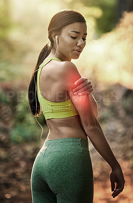 Buy stock photo Shot of a sporty young woman experiencing upper arm pain