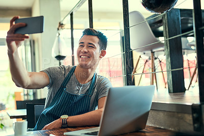 Buy stock photo Waiter, laptop and man with selfie at cafe for small business, website update and digital post. Hospitality, restaurant and employee with photography by table for service industry, media and memory