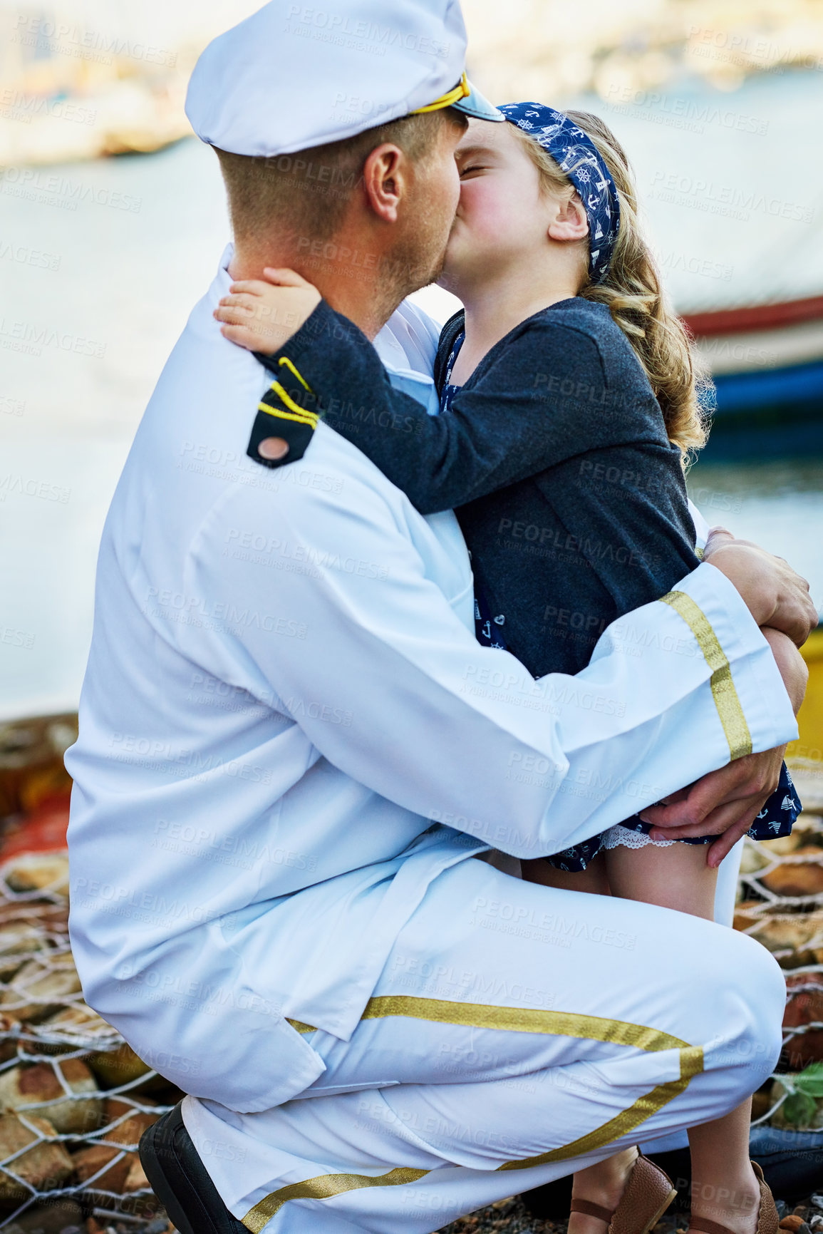 Buy stock photo Navy, father and young child with kiss for reunion, love and welcome by dock on seaside. Male person, girl and hug on shore for farewell, service and sailor in uniform for duty, care and trust