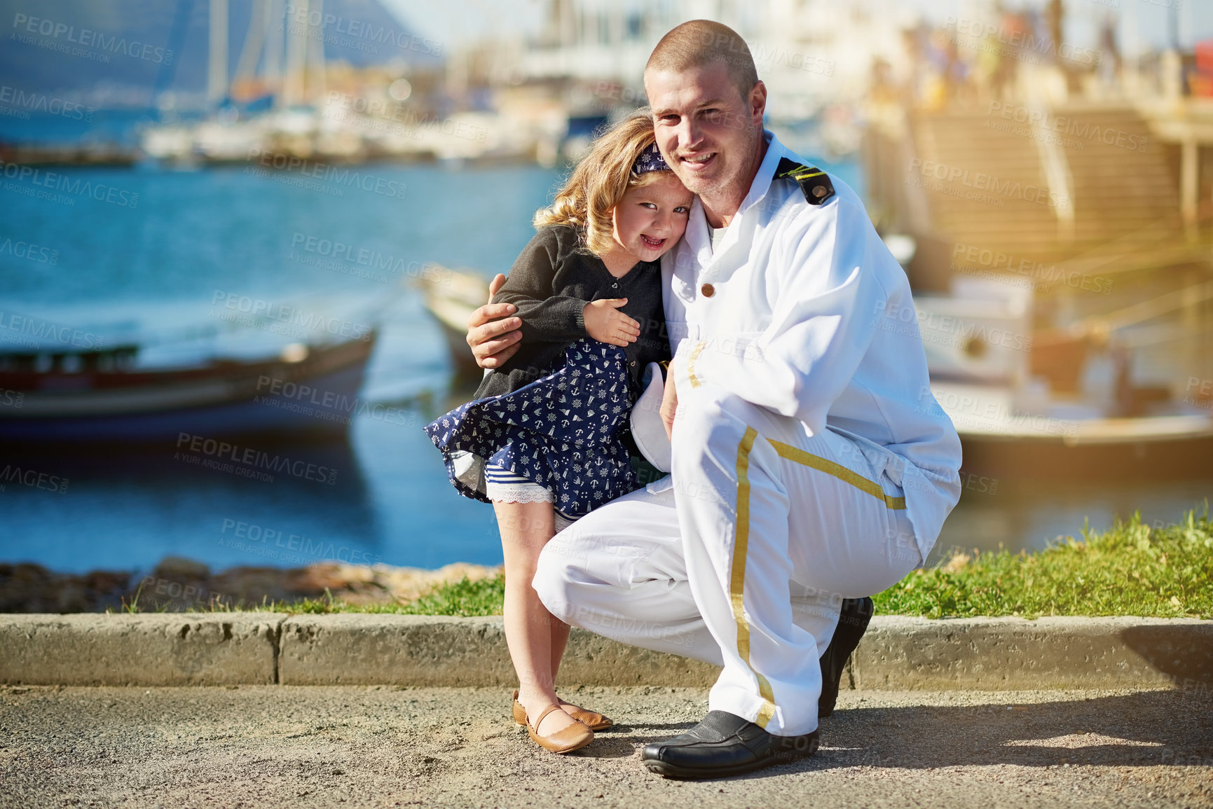 Buy stock photo Portrait of a father in a navy uniform posing with his little girl on the dock