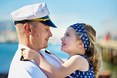 Buy stock photo Shot of a father in a navy uniform bonding with his little girl on the dock
