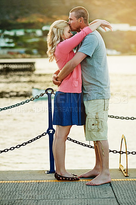 Buy stock photo Hug, love kiss and couple at dock with happiness for ocean holiday adventure and commitment for marriage. Man, woman and care with embrace for travel by water and summer vacation together in Florida