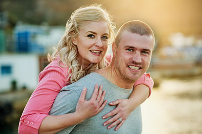 Buy stock photo Piggyback, portrait and couple by water with love for summer vacation together and commitment for marriage trust. Man, woman and hug with smile for sea travel and ocean holiday adventure in Amsterdam