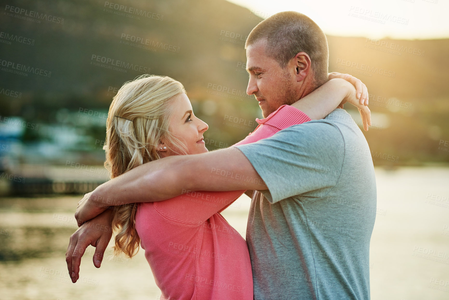 Buy stock photo Shot of an affectionate couple bonding at the beach