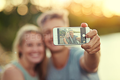 Buy stock photo Cropped shot of a young couple taking a selfie together outside