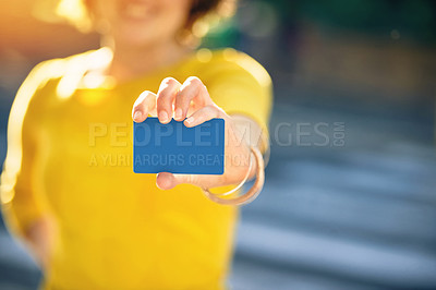 Buy stock photo Shot of an unrecognizable young woman holding a credit card