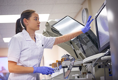 Buy stock photo Shot of a young scientist using a computer to conduct a medical test in a laboratory