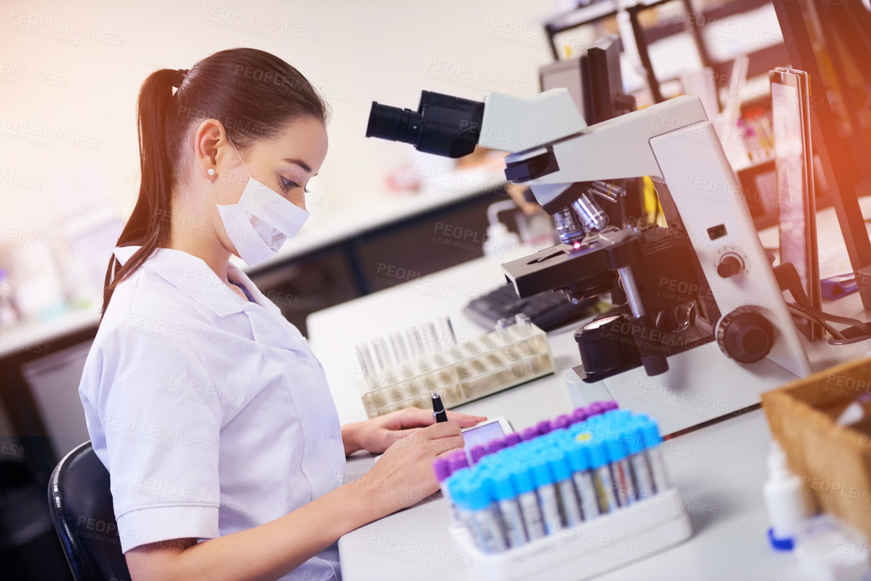 Buy stock photo Shot of a young scientist using a digital tablet while working in a laboratory