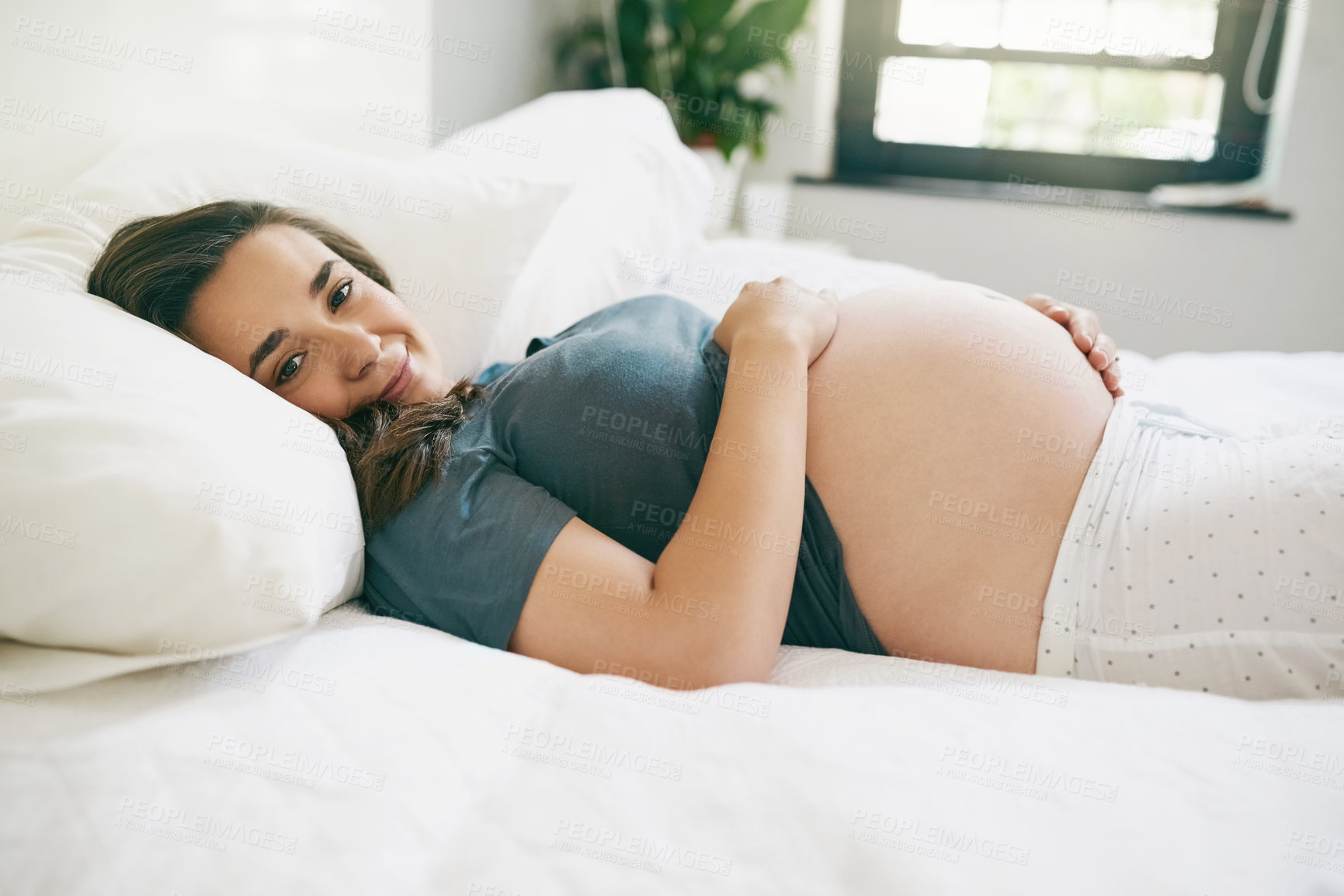 Buy stock photo Portrait, smile and pregnant woman touch stomach in home bedroom for relax, maternity or expecting baby. Pregnancy, future or happy mother on bed feel abdomen for health, motherhood or prenatal care