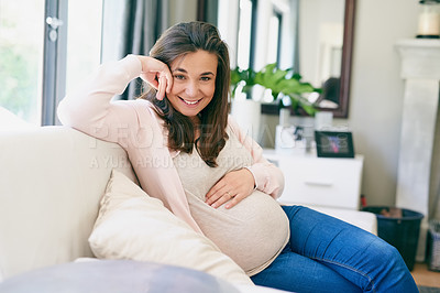 Buy stock photo Shot of a young pregnant woman relaxing at home