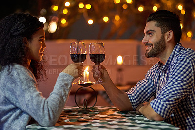 Buy stock photo Cropped shot of a young couple making a toast