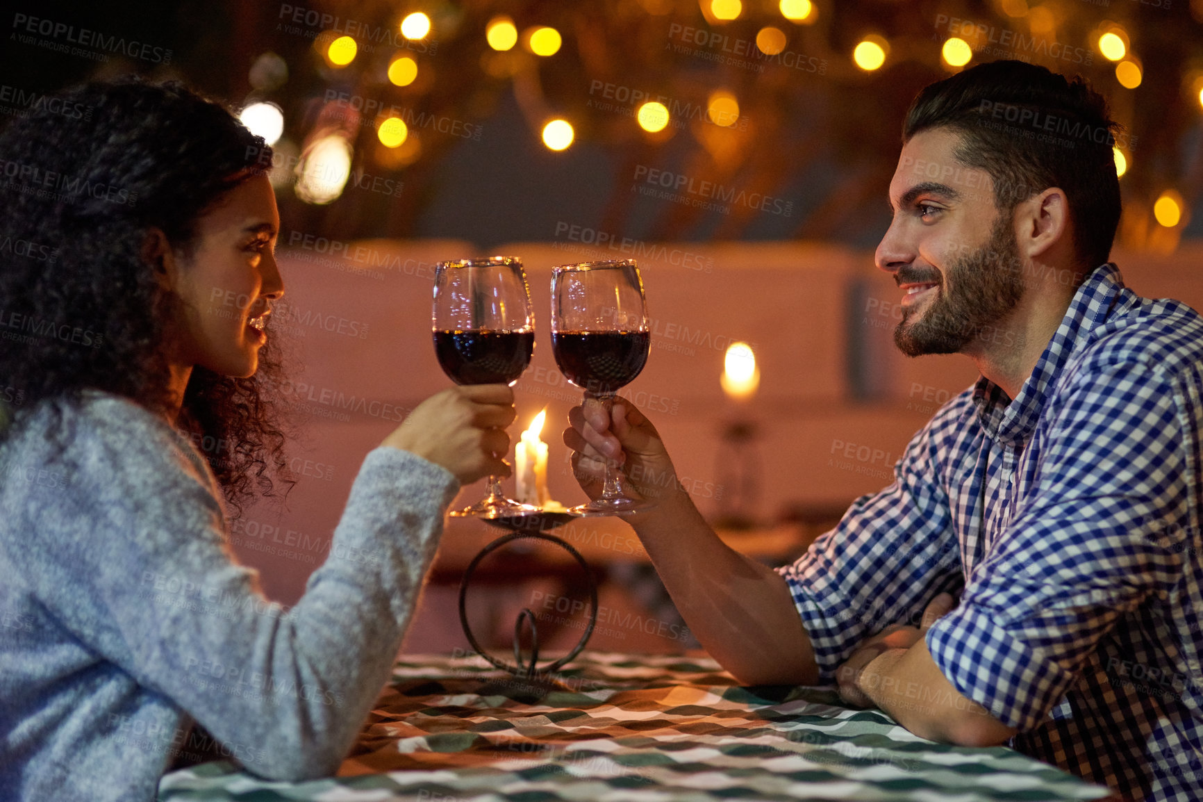 Buy stock photo Toast, date and couple with love, restaurant and marriage with happiness, celebration and romantic. People, red wine or man with woman, lights or trust with alcohol, care and dinner with joy or relax