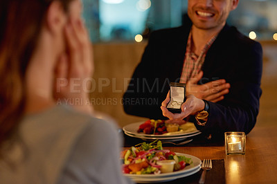 Buy stock photo Cropped shot of a young man proposing to his girlfriend