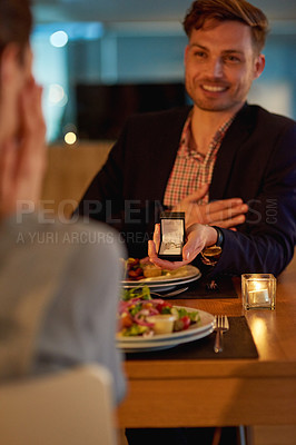Buy stock photo Cropped shot of a young man proposing to his girlfriend