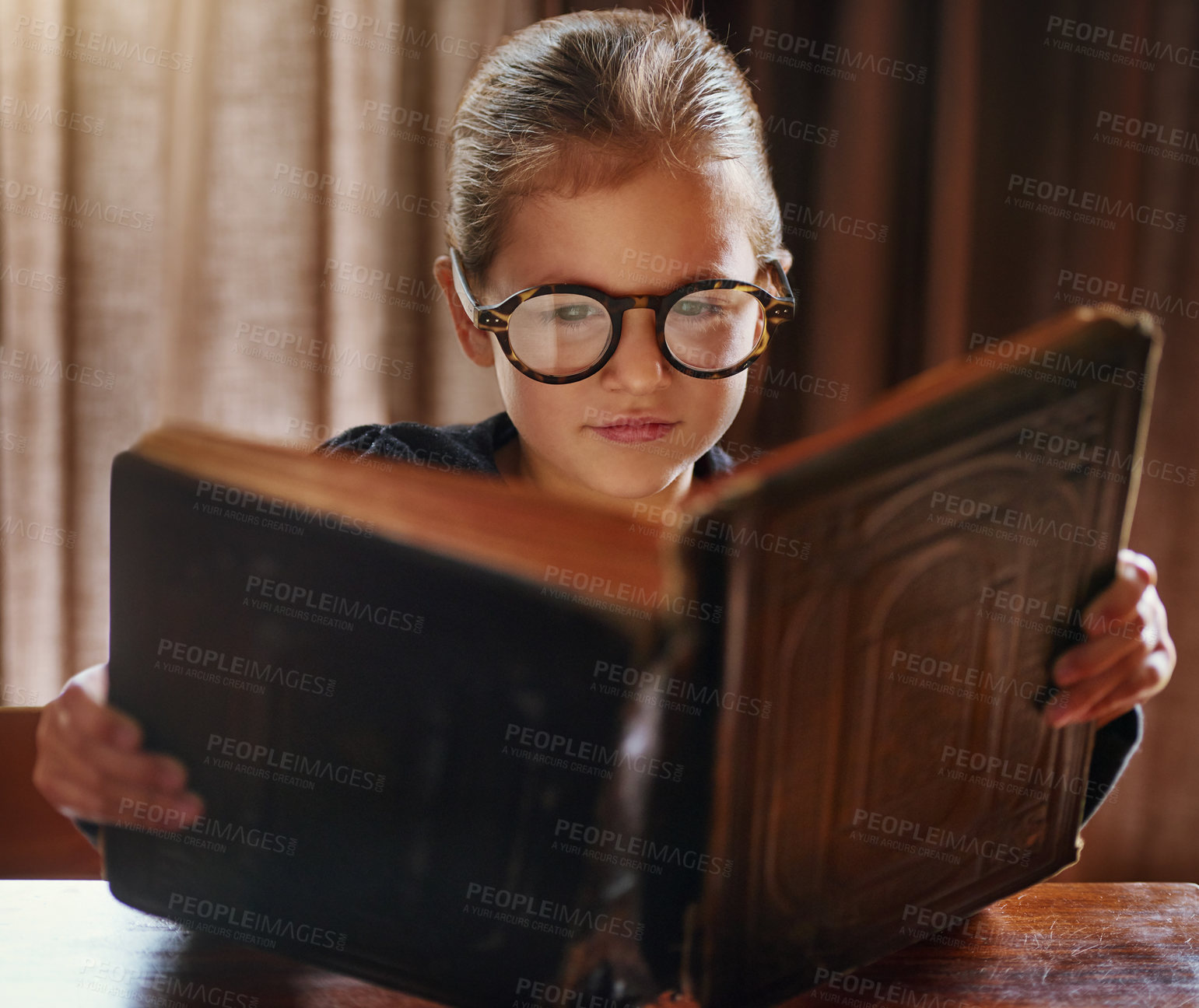 Buy stock photo Cropped shot of a little girl reading a book