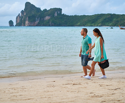 Buy stock photo Couple, walking and relax at beach with love, summer and travel for vacation by ocean. Man, woman and peace or calm by sea outdoor with romance, date and freedom for holiday by water in Greece