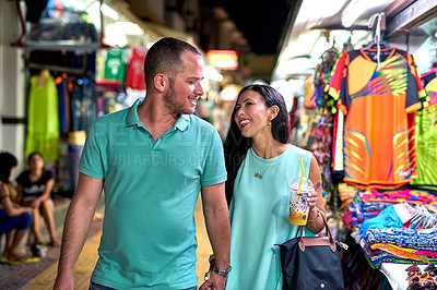 Buy stock photo Shot of a happy couple walking hand in hand