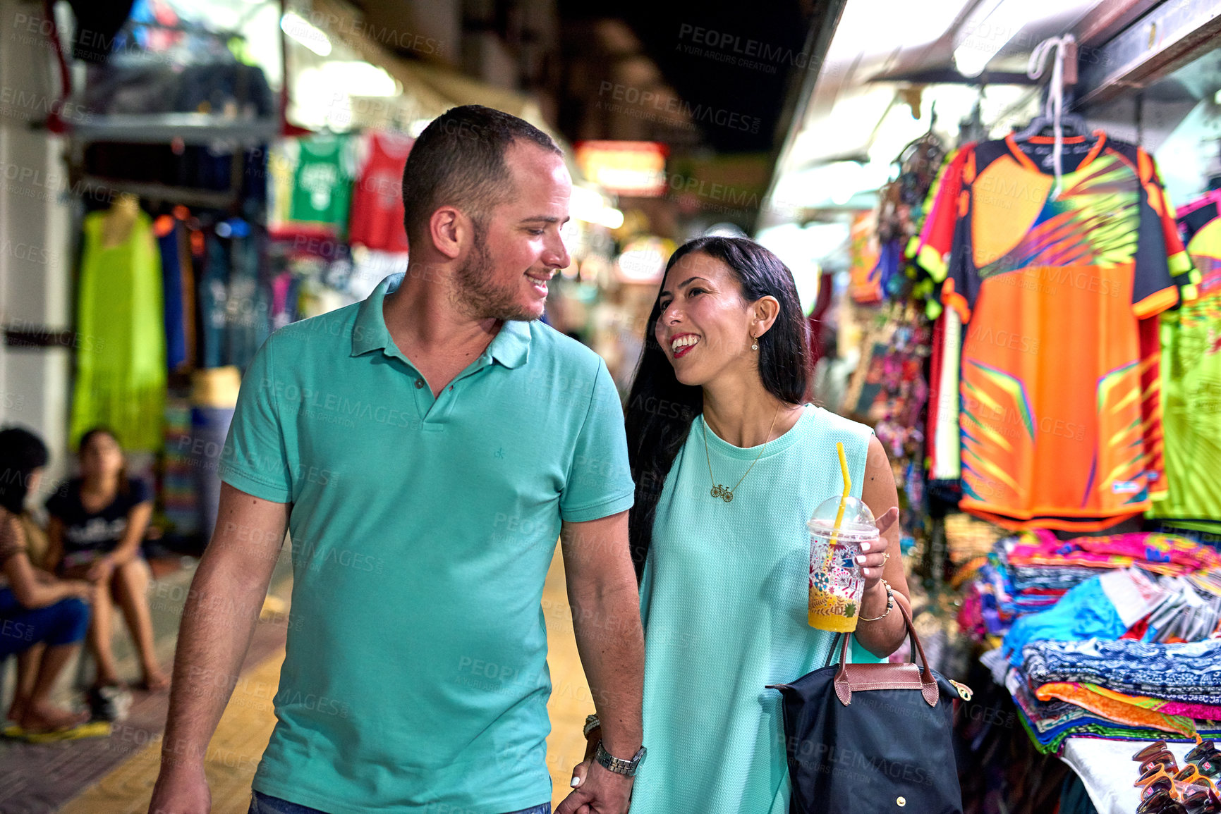 Buy stock photo Shot of a happy couple walking hand in hand