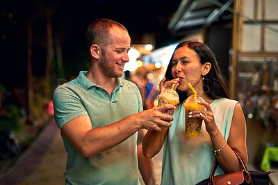 Buy stock photo Shot of a woman tasting her husband's smoothie