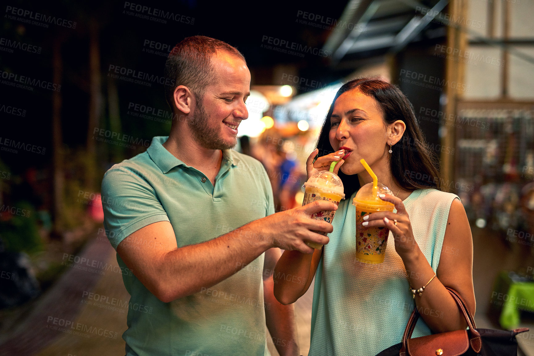 Buy stock photo Shot of a woman tasting her husband's smoothie