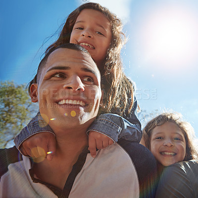 Buy stock photo Portrait of a happy young man spending time with his daughters outdoors