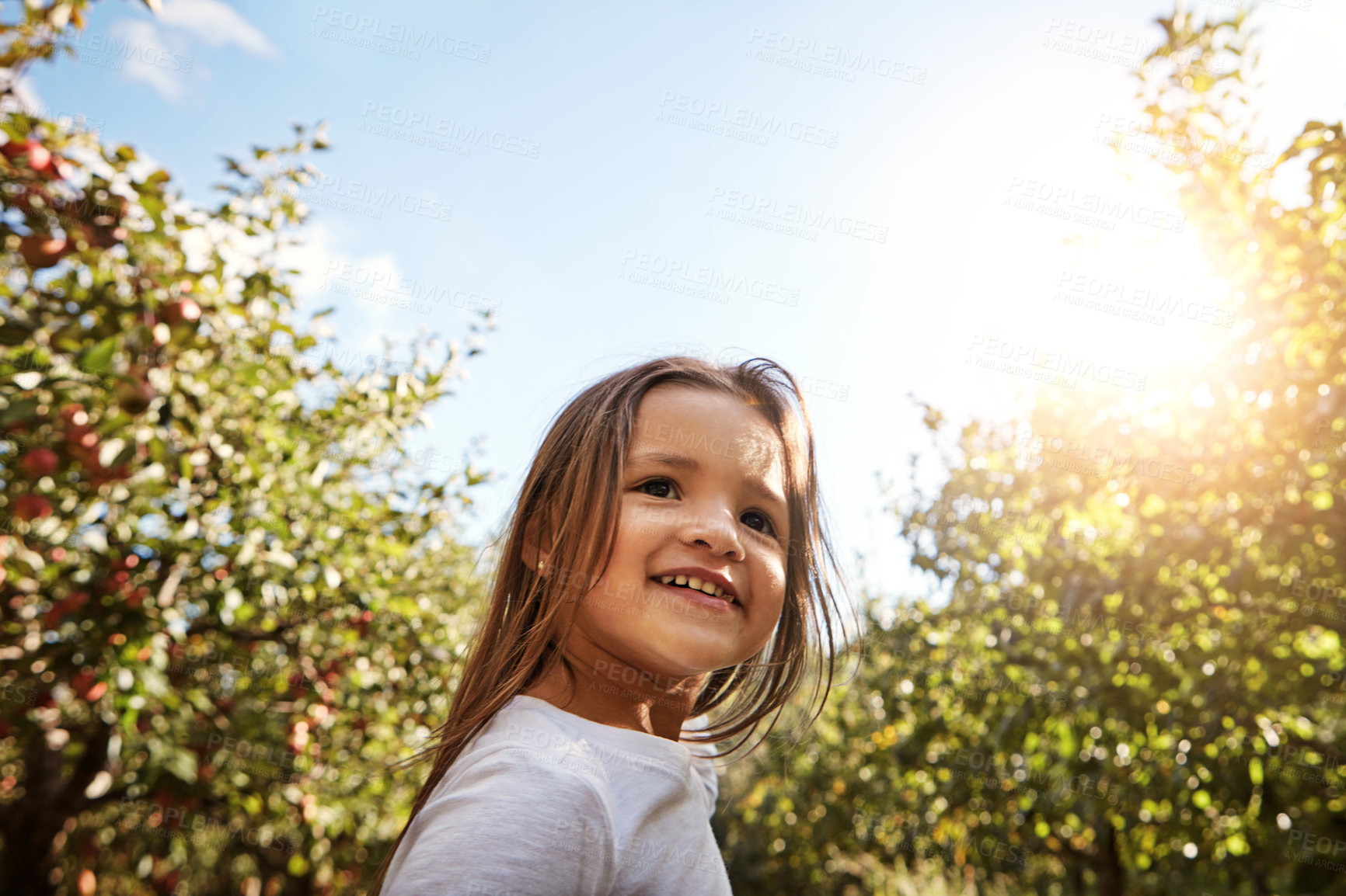 Buy stock photo Shot of an adorable little girl enjoying a day in nature