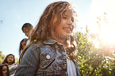 Buy stock photo Shot of a happy girl enjoying a day in nature with her family