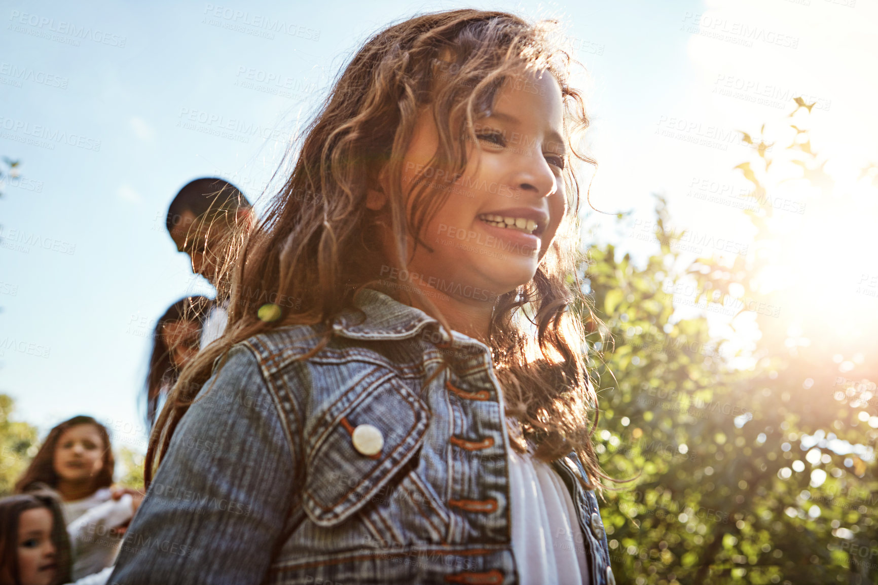 Buy stock photo Shot of a happy girl enjoying a day in nature with her family