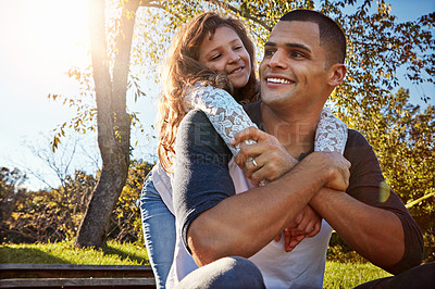 Buy stock photo Shot of a happy father and daughter spending time together outdoors