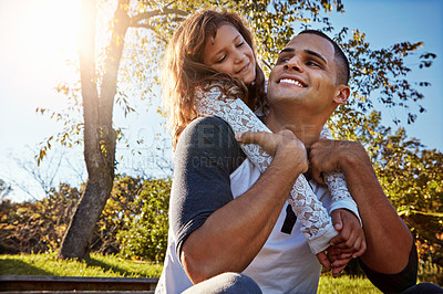 Buy stock photo Shot of a happy father and daughter spending time together outdoors