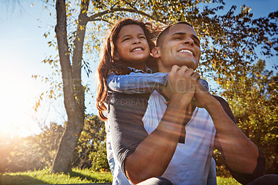 Buy stock photo Shot of a happy father and daughter spending time together outdoors