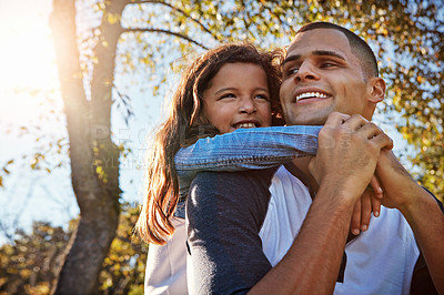 Buy stock photo Shot of a happy father and daughter spending time together outdoors